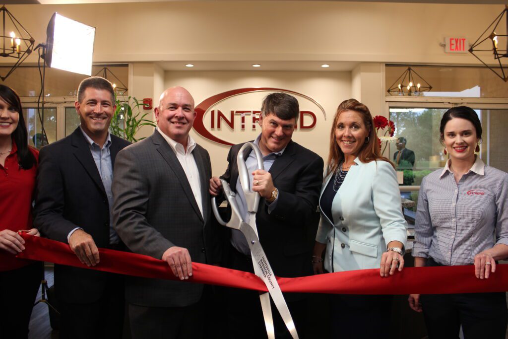 Intrepid Group smiles and cuts ribbon