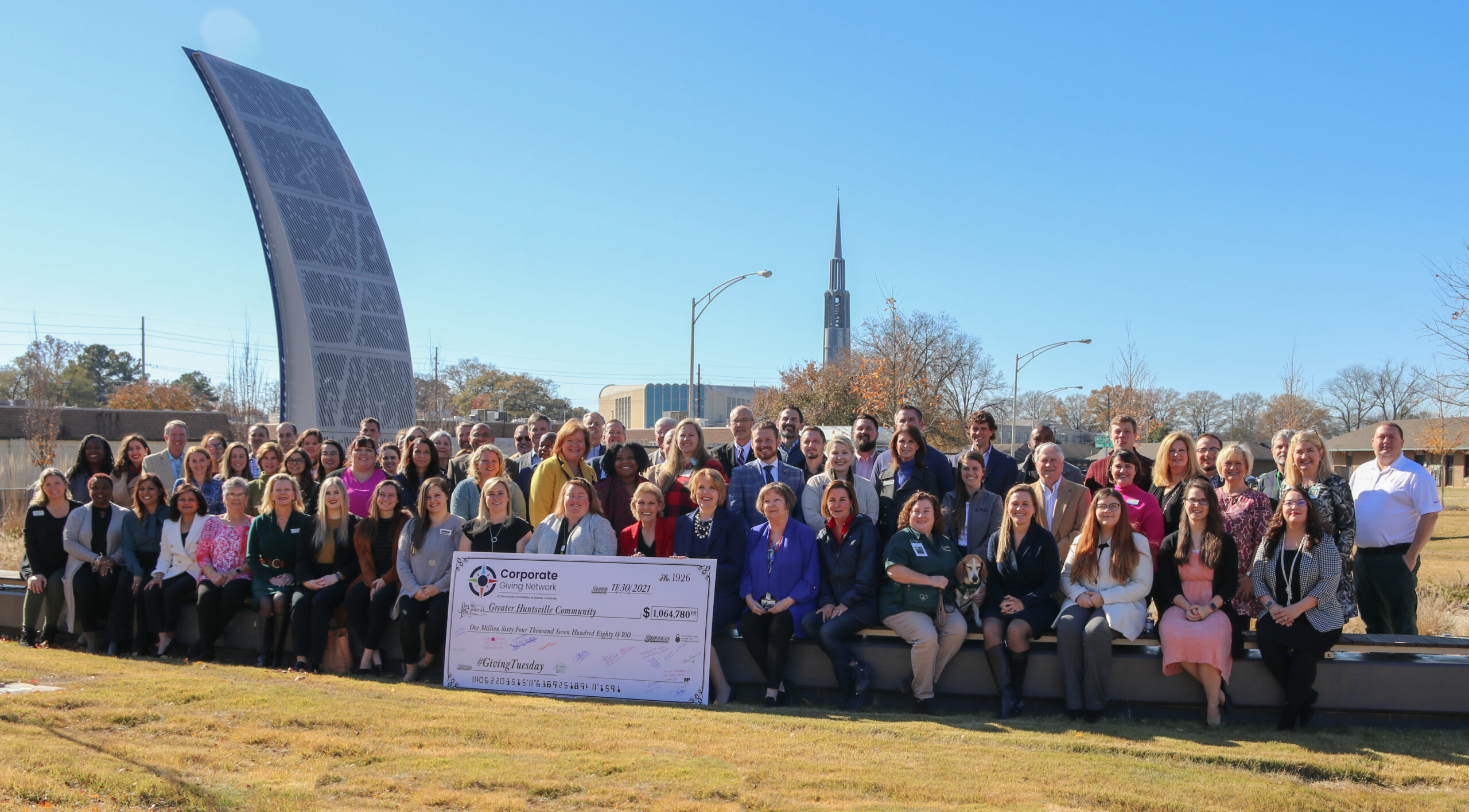 Corporate Giving Network poses with check